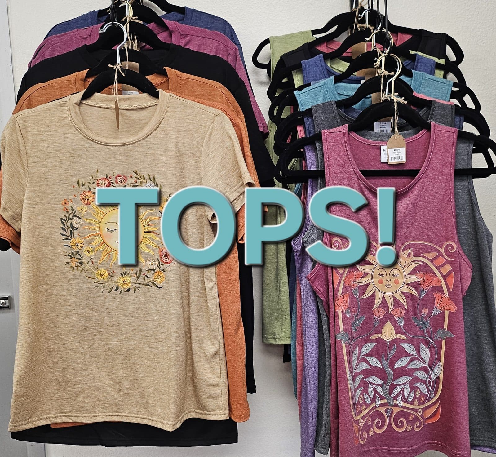 Printed tees and tanks hanging on a rack, captioned “Tops!”.